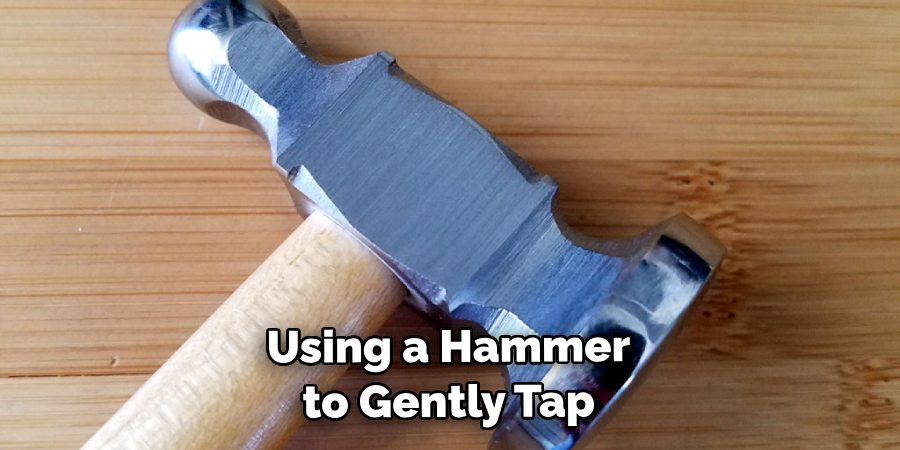 Using a Hammer to Gently Tap