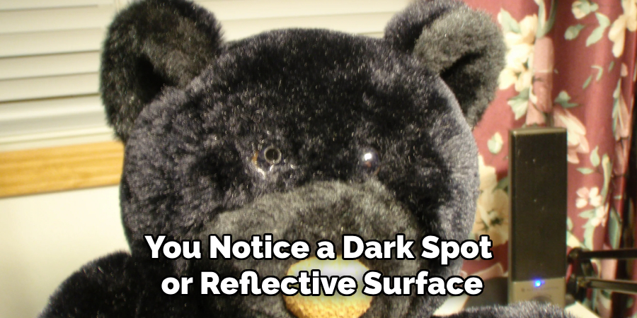 You Notice a Dark Spot or Reflective Surface