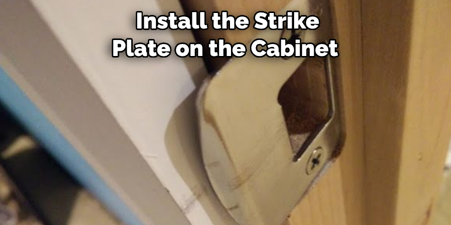 Install the Strike Plate on the Cabinet