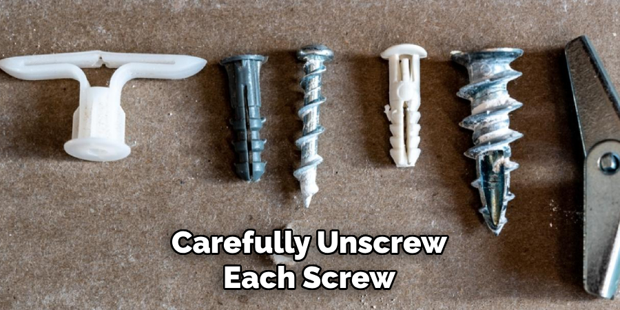 Carefully Unscrew Each Screw