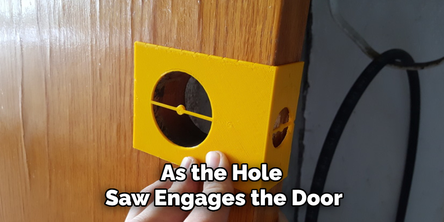 As the Hole 
Saw Engages the Door