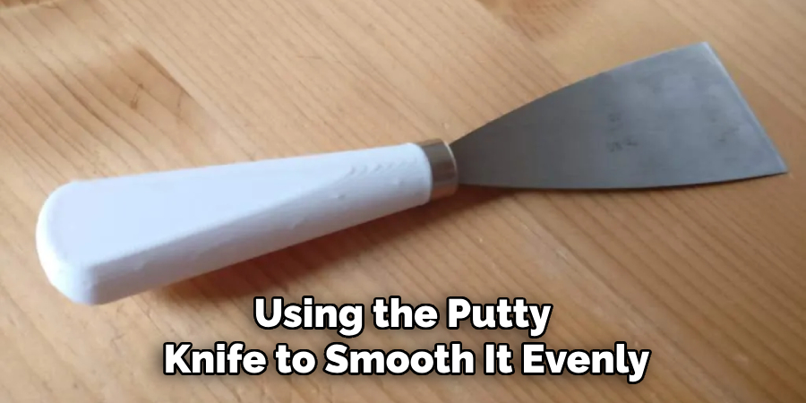 Using the Putty 
Knife to Smooth It Evenly