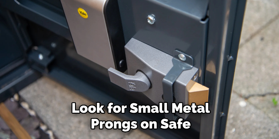 Look for small metal prongs on safe