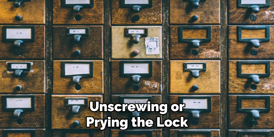 Unscrewing or Prying the Lock