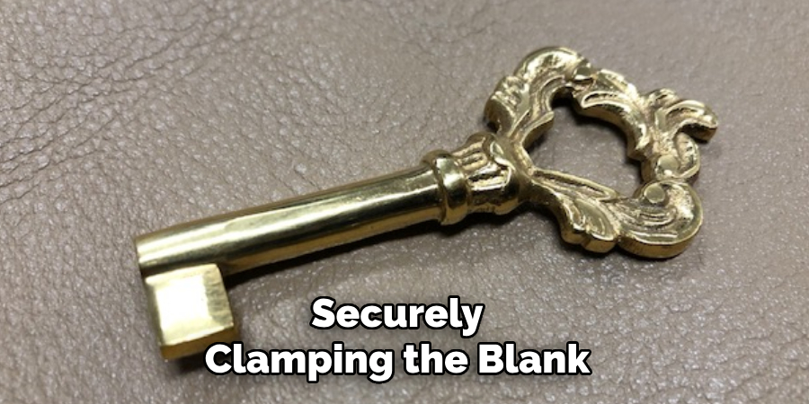 securely clamping the blank