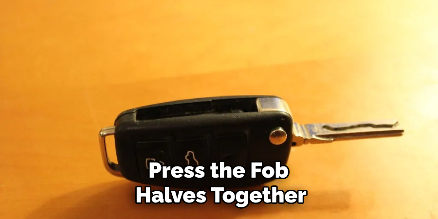 Press the fob halves together