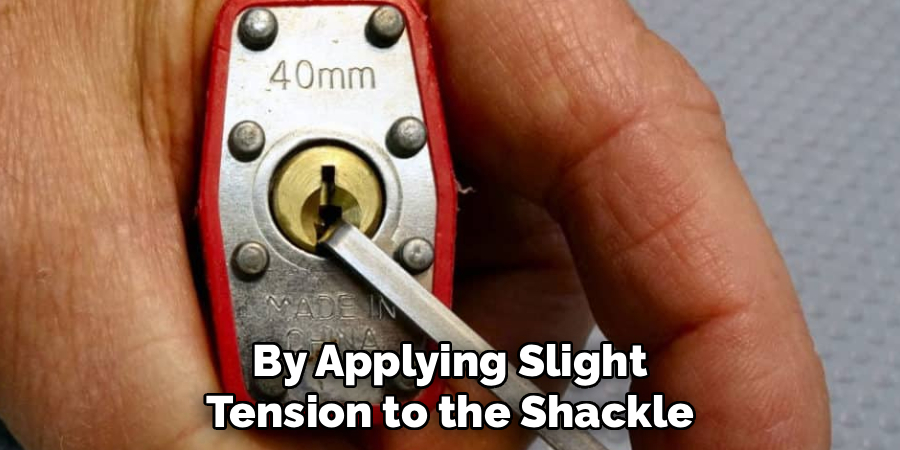 By Applying Slight
Tension to the Shackle